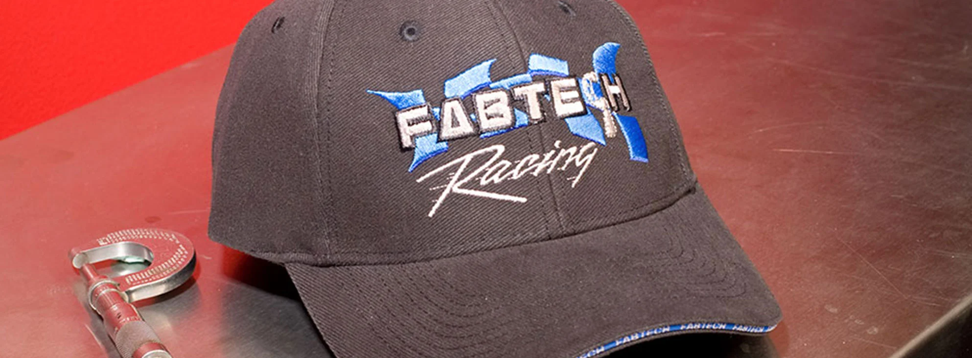 Fabtech Motorsports logo design on baseball cap by Dogs of Design – branded apparel for off-road and motorsport lifestyle