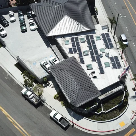 Aerial perspective of a street with vehicles and the Lexology Auto Shop building, taken by Dogs of Design